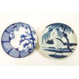 Two Chinese porcelain blue and white chargers, one with a heron in a landscape,