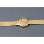 A yellow metal wristwatch by Omega.