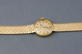 A yellow metal wristwatch by Omega.