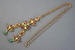 A yellow metal abstract pendant set with rhodolite garnets,