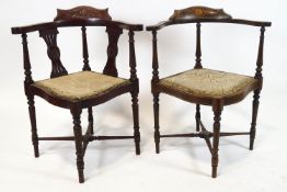 An Edwardian mahogany and marquetry corner chair on turned tapering legs linked by stretchers,