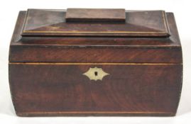 A George IV mahogany tea caddy, of sarcophagus form, with boxwood stringing and brass escutcheon.