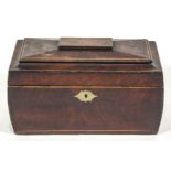 A George IV mahogany tea caddy, of sarcophagus form, with boxwood stringing and brass escutcheon.