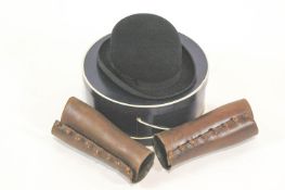 A boxed Dunn & Co 7 5/8 size bowler hat and a pair of gaiters