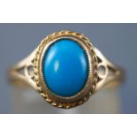 A yellow metal single stone ring. Set with an oval cabochon cut turquoise. Hallmarked 9ct gold.