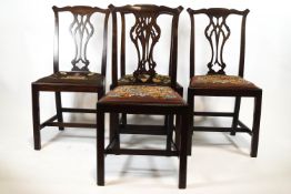 A set of six mahogany George III style dining chairs comprising two elbow and four side chairs,