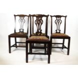 A set of six mahogany George III style dining chairs comprising two elbow and four side chairs,