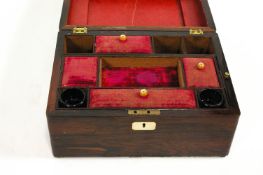 A Victorian rosewood sewing box, with mother of pearl inlaid escutcheon and part fitted interior,