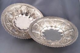 A pair of silver low form fruit bowls, raised on trumpet feet,