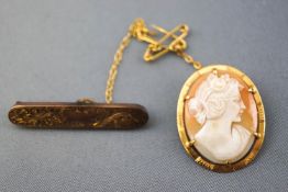 A collection of two brooches to include a filigree bar brooch with pin and safety chain,