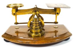 An early 20th century brass set of letter scales with weights,