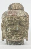 A carved stone head of Buddha, traces of polychrome decoration,