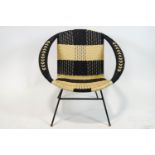 A 1960's black and white faux wicker chair on metal legs,