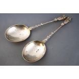 A pair of large silver Apostle type spoons with terminal figures of a pilgrim holding a book and