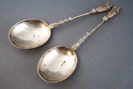 A pair of large silver Apostle type spoons with terminal figures of a pilgrim holding a book and