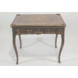 A 20th century French kingwood and marquetry games table the top opening to reveal a baise top and