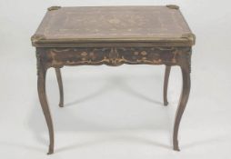 A 20th century French kingwood and marquetry games table the top opening to reveal a baise top and