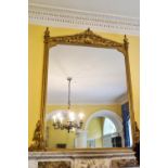 A 19th century gilt framed over-mantel mirror with scrolls to the architectural pediment,