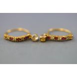 A yellow metal pair of hoop earrings set with synthetic rubies and colourless cubic zirconia.