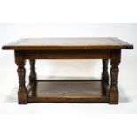 A period style elm coffee table with a three plank style top raised on turned legs on a solid base