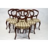 A set of six Victorian mahogany balloon back chairs with stuff over seats on cabriole legs,