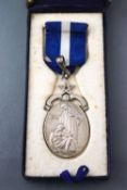 A silver pendant medal in fitted case. Hallmarked sterling silver, London, 1951. 38.