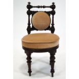 A 19th century mahogany child's chair, with upholstered back and seat on turned tapering legs,