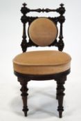 A 19th century mahogany child's chair, with upholstered back and seat on turned tapering legs,