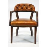 A mahogany office chair with curved leather button back,