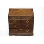 A George III Provincial oak bureau, with fall front on lopers,