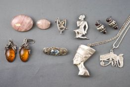 A collection of jewellery to include: Two oval rose quartz brooches; A wishbone brooch;