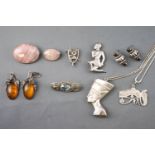 A collection of jewellery to include: Two oval rose quartz brooches; A wishbone brooch;