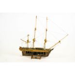 A cut-away wood scale model of HMS Bounty on stand,