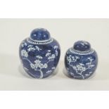 A graduated pair of Chinese blue and white ginger jars, decorated with prunus blossom,
