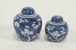 A graduated pair of Chinese blue and white ginger jars, decorated with prunus blossom,