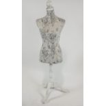 A dress makers mannequin on turned stem and triform base,