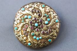 A yellow metal hollow case brooch, formed from an original watch case.