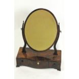 A mahogany swing frame oval dressing table mirror,