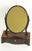 A mahogany swing frame oval dressing table mirror,