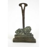 A 19th century brass door stop or door porter of a recumbent lion,