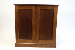 A Victorian mahogany two door cupboard, the twin panelled doors above plinth base,