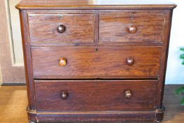 A Victorian mahogany chest of two short and two long drawers with turned handles,