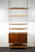 A Swedish painted metal and teak 'string' ladderax style wall unit with base cupboard set with two