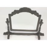 An oak framed dressing table mirror, the arched mirror with scrolled cresting rail,