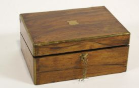 A Victorian mahogany and brass bound writing slope with a label to the interior,