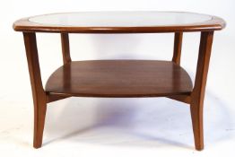 A G-plan style coffee table, the oval top with central glass panel,