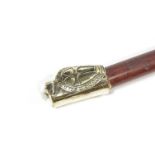 A walking stick with brass coat of arms knop,
