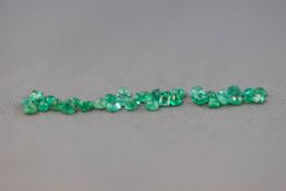 A collection of loose faceted cut round and square emeralds. Colour: Pale Bluish Green.