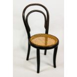 An early 20th century child's bentwood chair with cane seat,