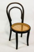 An early 20th century child's bentwood chair with cane seat,